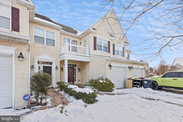 view of property featuring a garage and a balcony