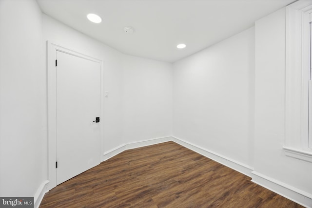 spare room featuring dark wood-type flooring