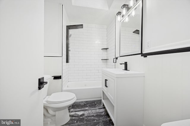 full bathroom featuring vanity, toilet, and tiled shower / bath