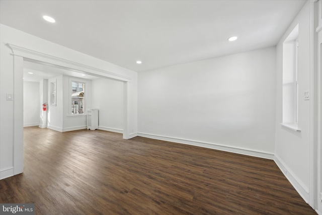 spare room featuring dark hardwood / wood-style floors and radiator