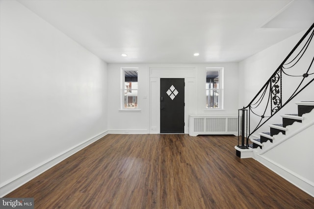 foyer with radiator heating unit and dark hardwood / wood-style floors