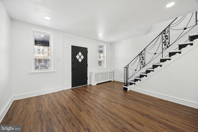 entrance foyer featuring dark hardwood / wood-style floors and radiator