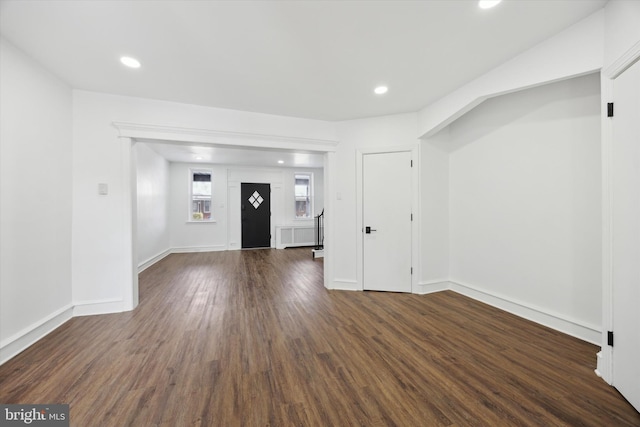 unfurnished living room featuring dark hardwood / wood-style floors