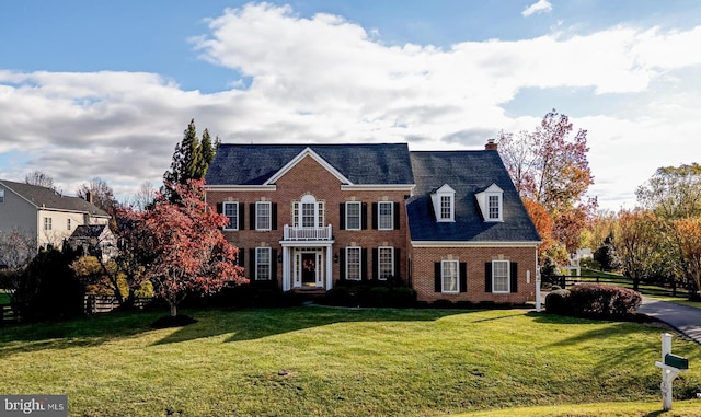 colonial-style house with a front yard