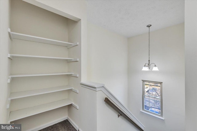 spacious closet with a notable chandelier