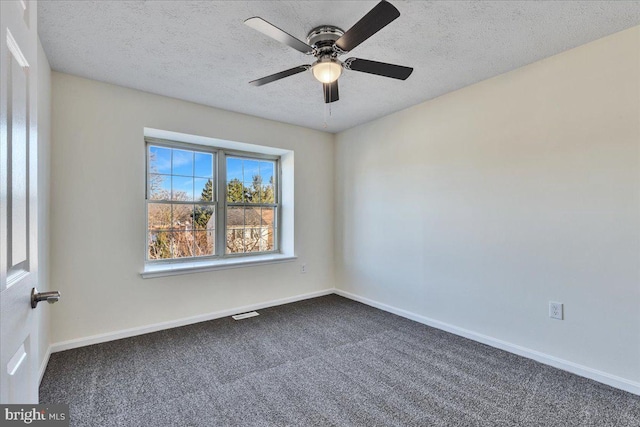 carpeted spare room with ceiling fan and a textured ceiling