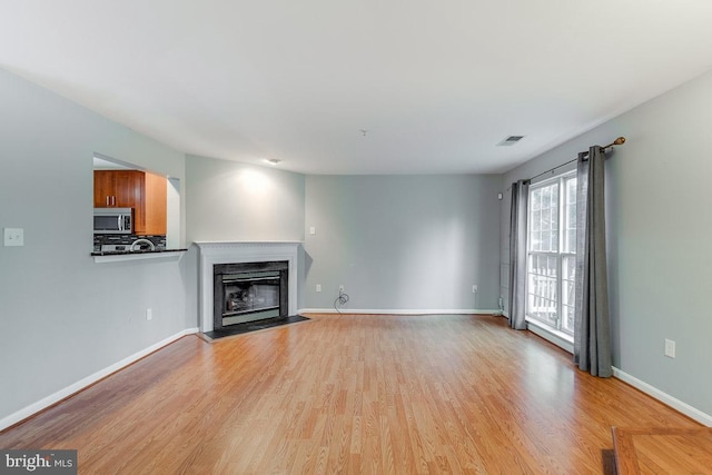 unfurnished living room featuring light wood-type flooring