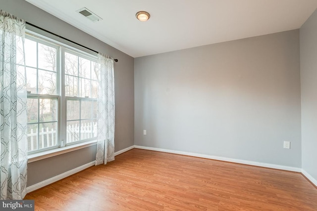 spare room with light hardwood / wood-style flooring