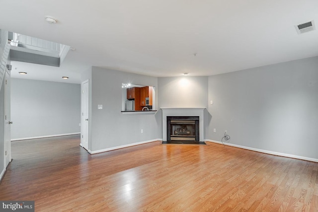 unfurnished living room featuring light wood-type flooring