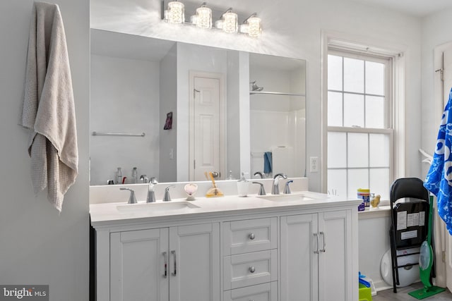 bathroom with a shower and vanity