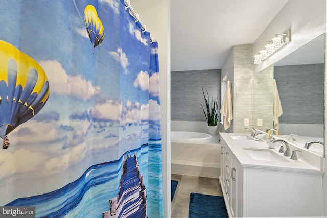 bathroom featuring tiled bath and vanity