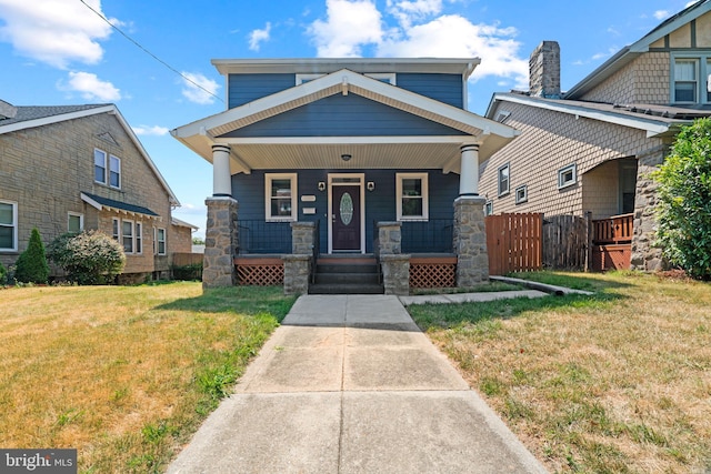 craftsman-style house with a porch and a front yard