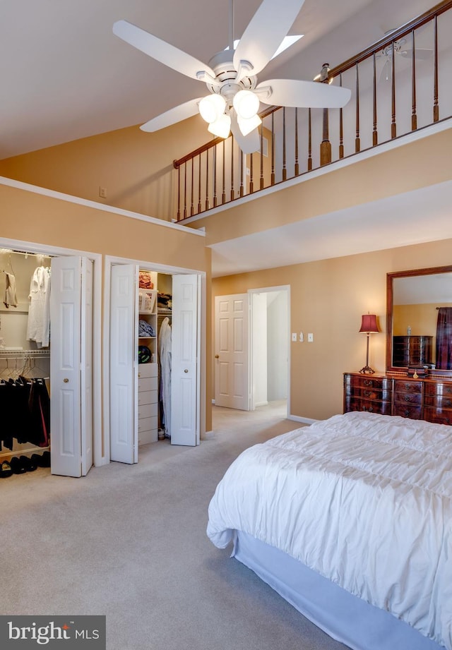 bedroom featuring ceiling fan, light colored carpet, and high vaulted ceiling