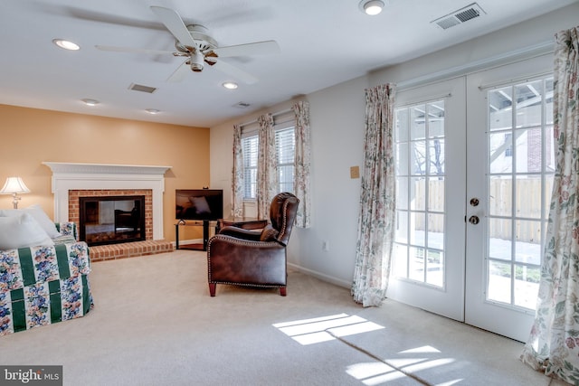 living area featuring light colored carpet, french doors, and plenty of natural light