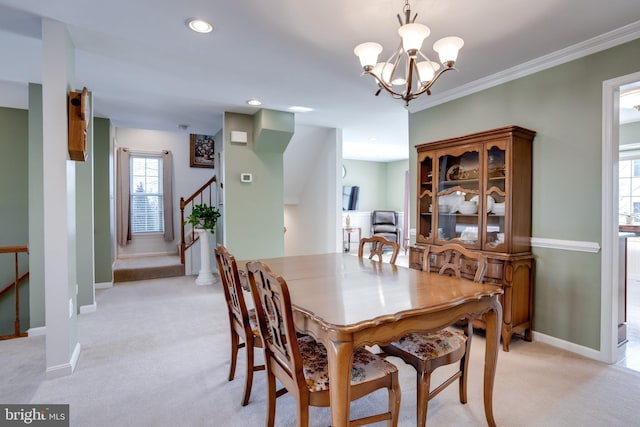 dining area featuring light colored carpet, crown molding, and a notable chandelier