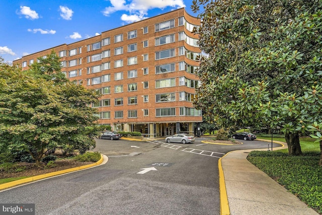 view of building exterior with uncovered parking