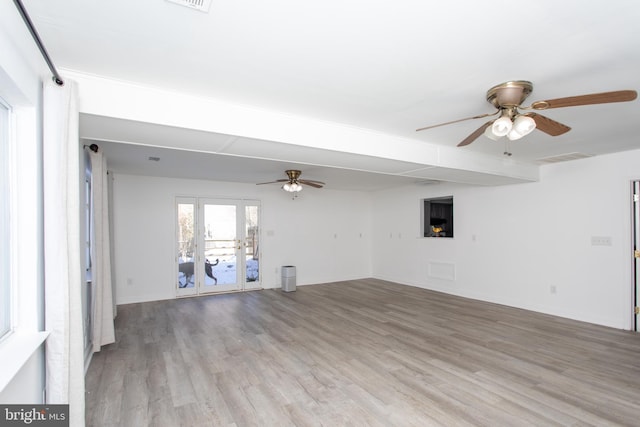 unfurnished living room with light hardwood / wood-style floors and ceiling fan