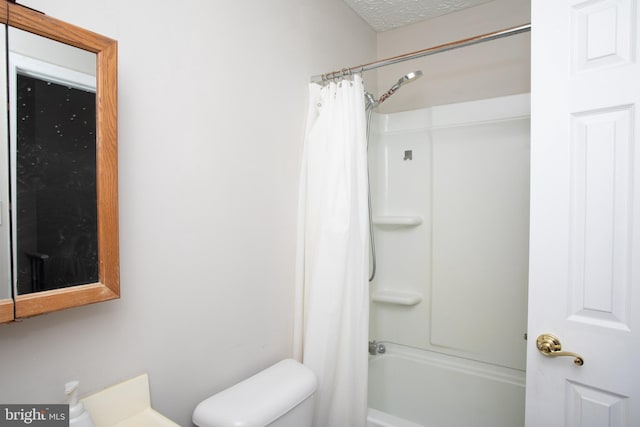 bathroom with a textured ceiling, toilet, and shower / bathtub combination with curtain