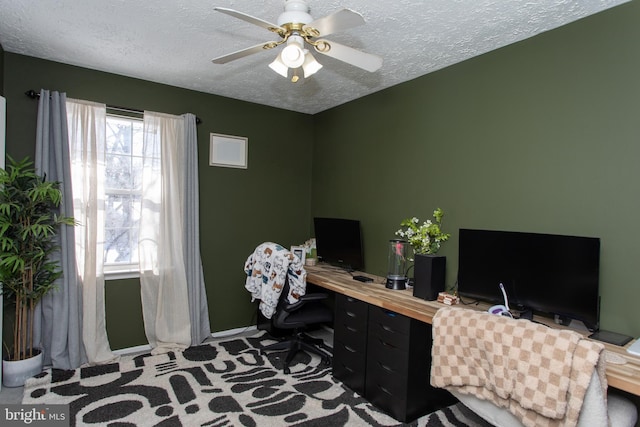 carpeted home office featuring ceiling fan and a textured ceiling