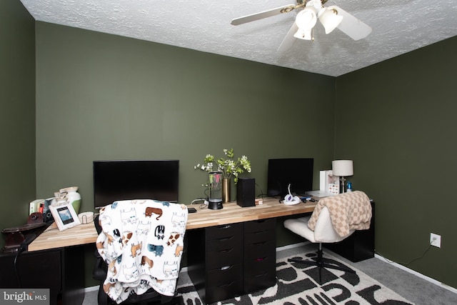 office area featuring ceiling fan, carpet floors, and a textured ceiling