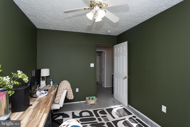 carpeted bedroom with ceiling fan and a textured ceiling