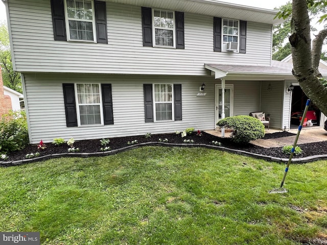 view of front of house with cooling unit and a front yard