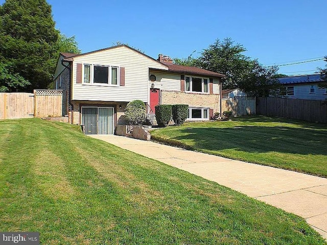 raised ranch featuring a front yard