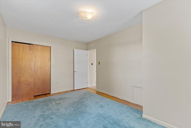 unfurnished bedroom featuring hardwood / wood-style floors and a closet