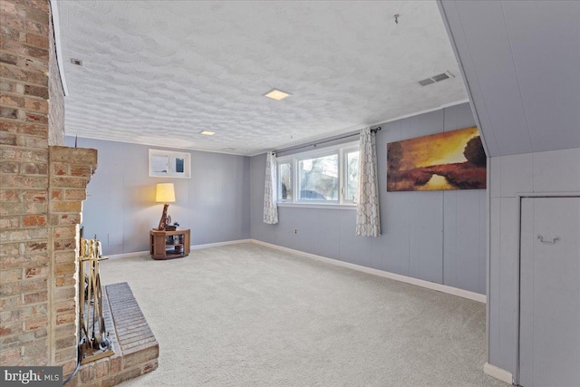 basement with light carpet and a textured ceiling