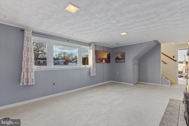 interior space with a textured ceiling and light colored carpet