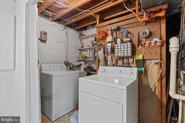 clothes washing area featuring a workshop area and washing machine and clothes dryer