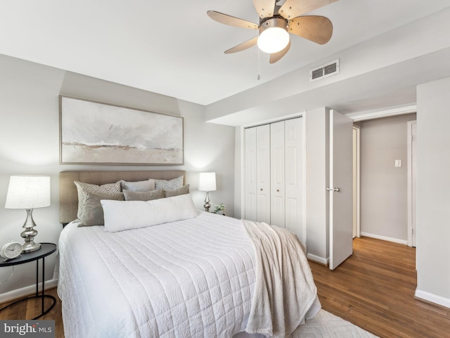 bedroom with ceiling fan, dark hardwood / wood-style flooring, and a closet