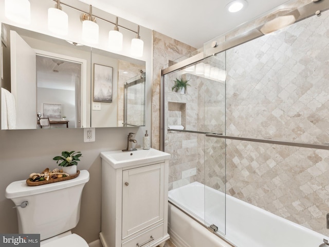 full bathroom featuring toilet, enclosed tub / shower combo, and vanity