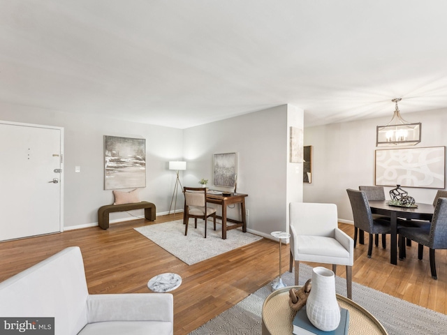 living room featuring hardwood / wood-style flooring and a chandelier