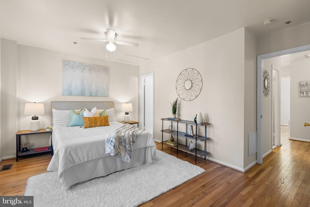 bedroom with ceiling fan and hardwood / wood-style flooring