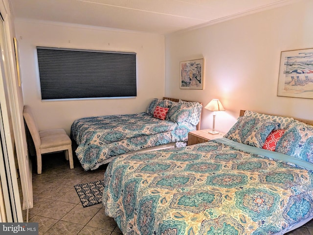 bedroom featuring crown molding and tile patterned flooring