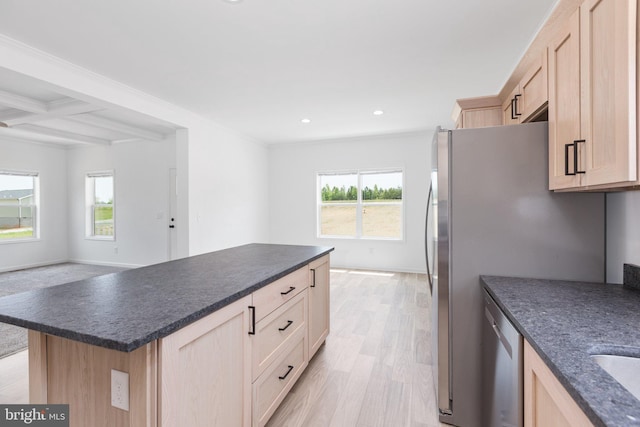 kitchen with beamed ceiling, light brown cabinets, light hardwood / wood-style floors, and coffered ceiling