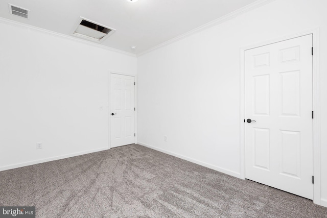 carpeted empty room featuring crown molding