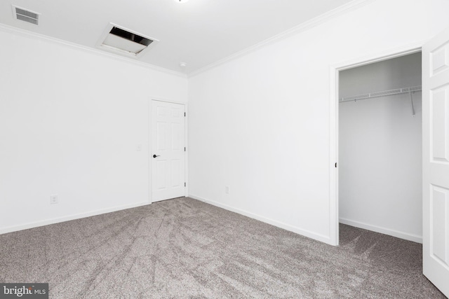 unfurnished bedroom featuring carpet flooring, crown molding, and a closet