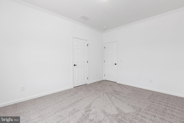 spare room featuring carpet floors and ornamental molding