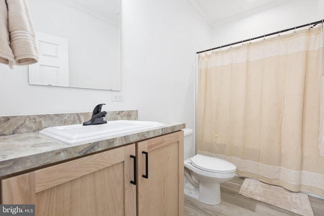 bathroom featuring hardwood / wood-style floors, vanity, toilet, and crown molding