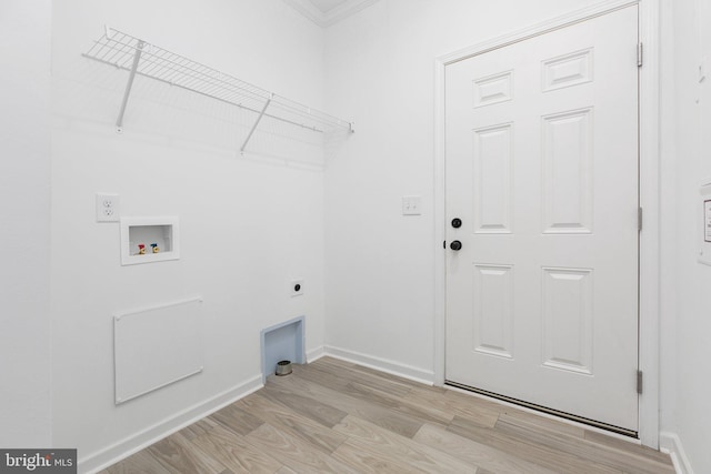 washroom featuring washer hookup, electric dryer hookup, crown molding, and light hardwood / wood-style flooring