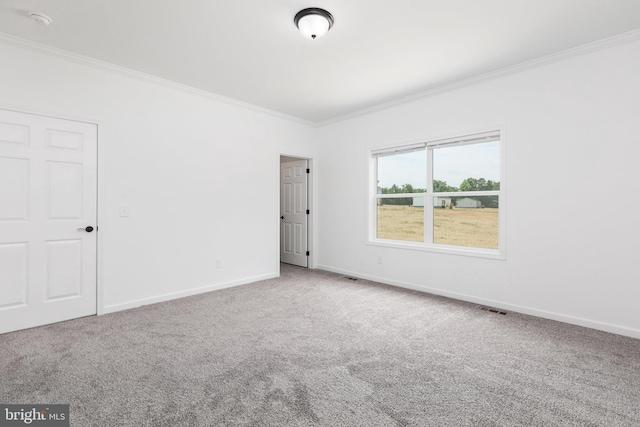 carpeted spare room with ornamental molding