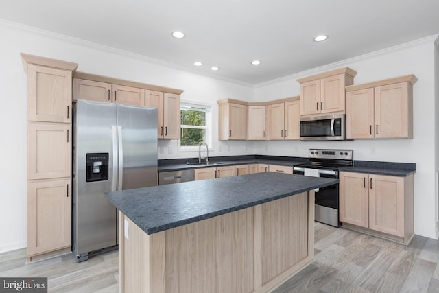 kitchen with sink, ornamental molding, stainless steel appliances, and light brown cabinetry