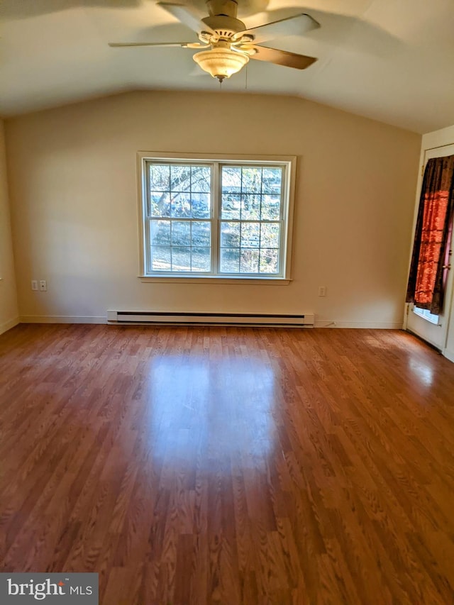 unfurnished room featuring lofted ceiling, baseboard heating, and hardwood / wood-style flooring