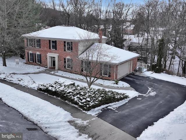 view of front of home featuring a garage and central air condition unit