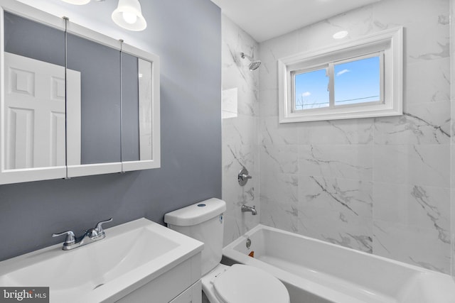 full bathroom featuring tiled shower / bath combo, toilet, and vanity