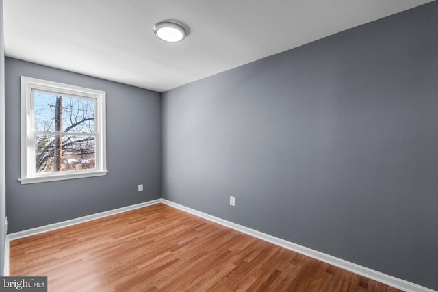 unfurnished room with light wood-type flooring