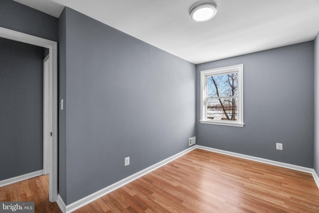 spare room with wood-type flooring