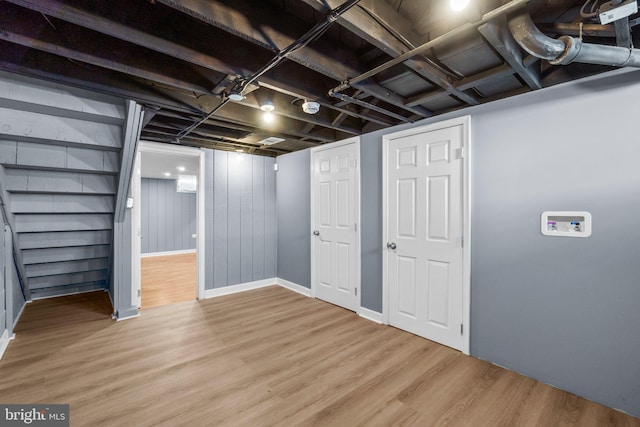 basement with light hardwood / wood-style floors